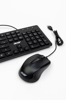 Close-up of a black Acer keyboard and mouse set against a white background.