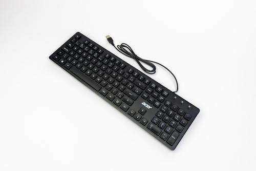 A black keyboard with a cord attached to it