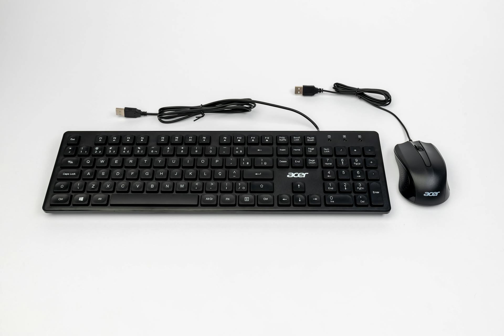 Black Keyboard and Black Computer Mouse on a White Background