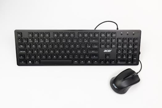 Top view of a black Acer keyboard and wired mouse on a clean white background.