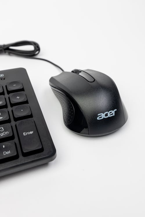 A computer mouse and keyboard next to each other