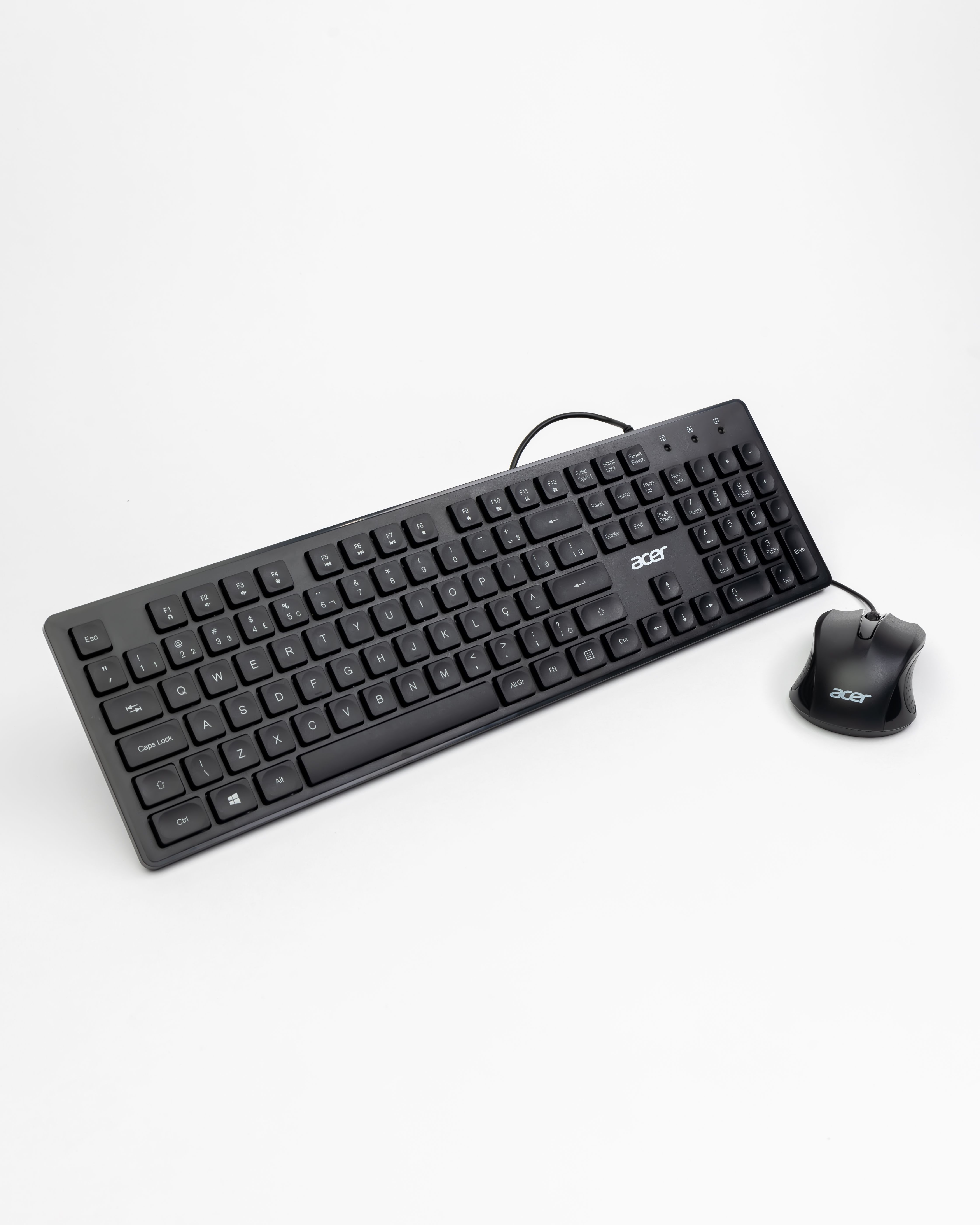 Black wired keyboard and mouse set on a white background in a vertical shot.
