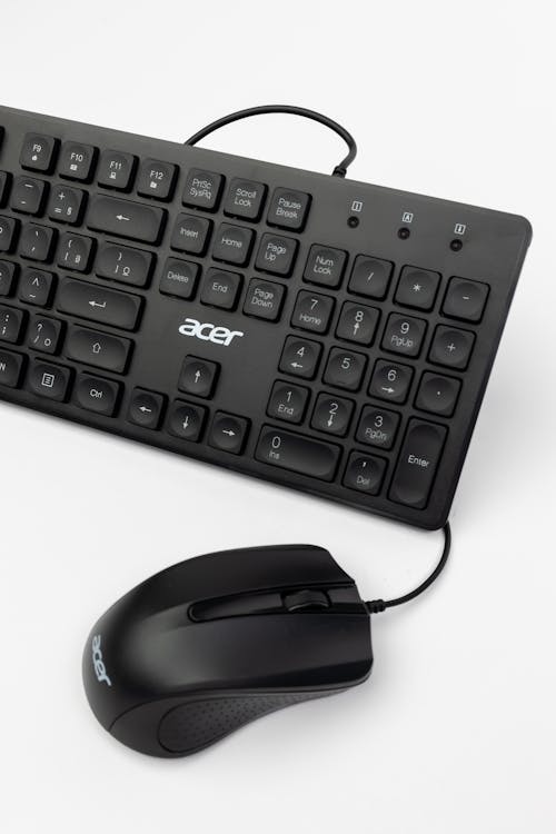 A Black Computer Keyboard and Mouse on White Background 