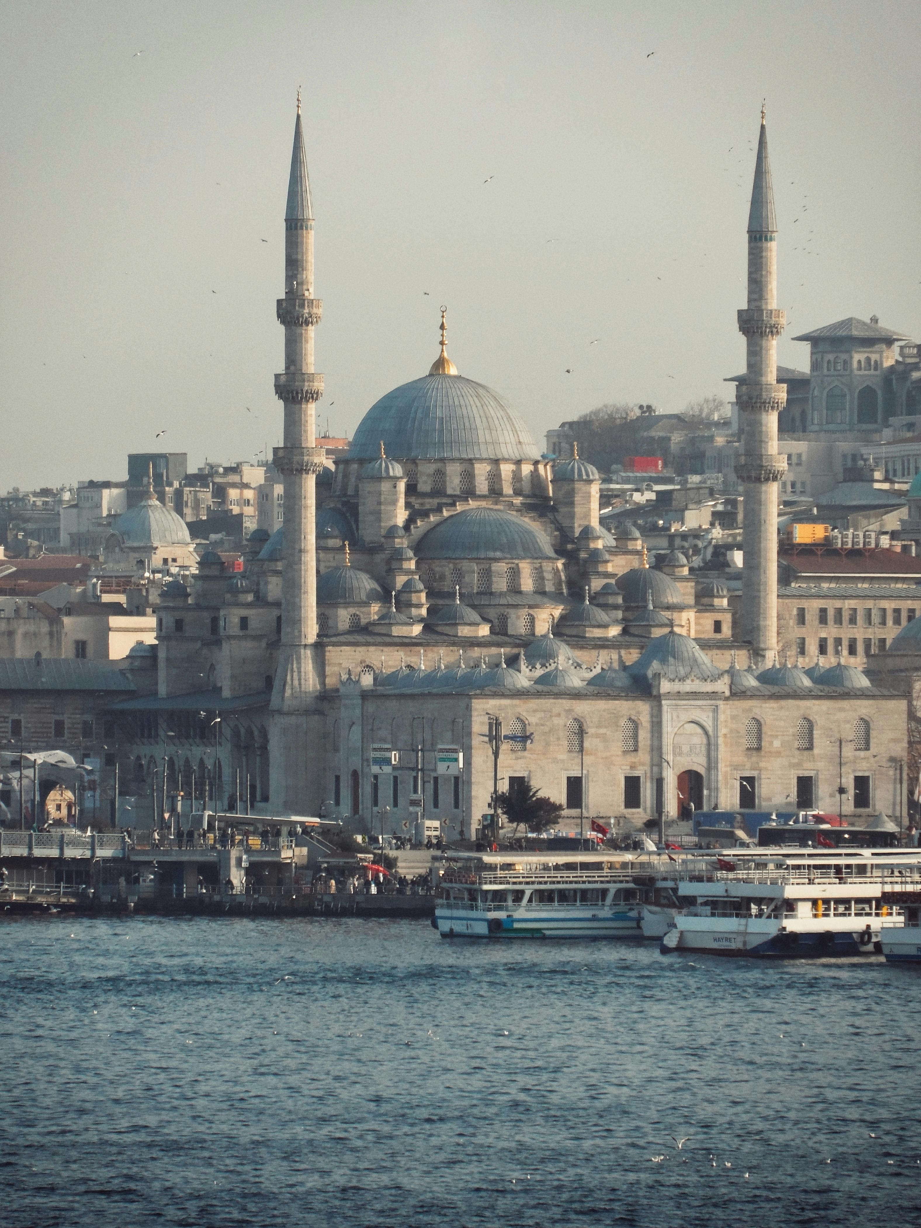 A scenic view of the New Mosque and surrounding harbor in Istanbul, Turkey.