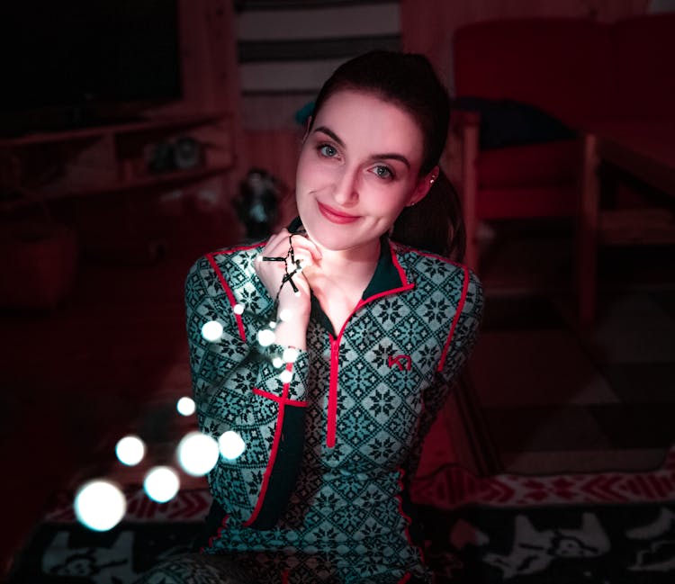 Woman Holding String Lights