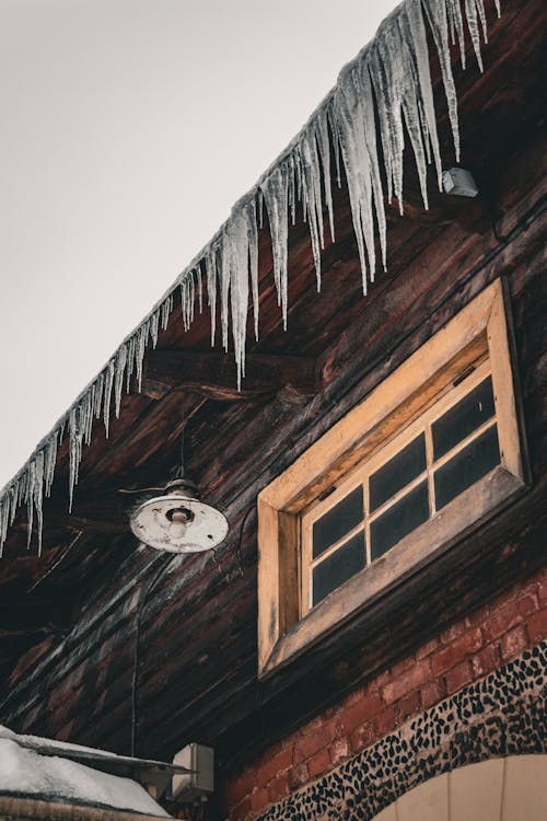 View of Icicles Hanging from the Roof of an Old Building 