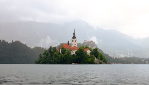 A small island with a church on it in the middle of a lake