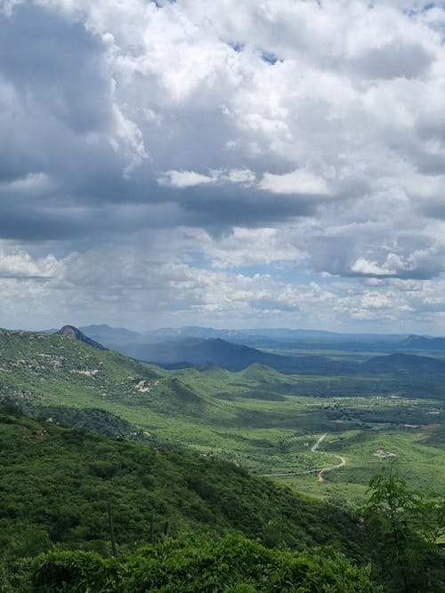 Scenic View of Green Mountains under a Cloudy Sky 