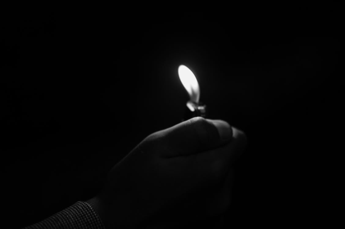 Free Close-up of Hand Holding Candle in Darkroom Stock Photo