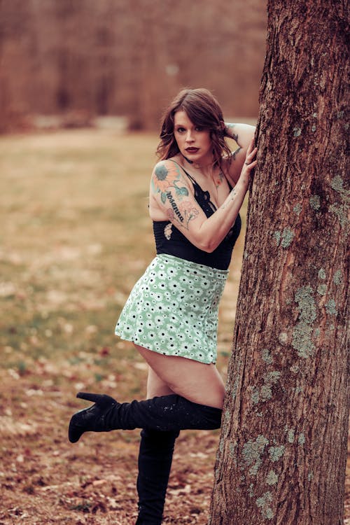 Attractive Woman in Black Top and Skirt Posing by Tree