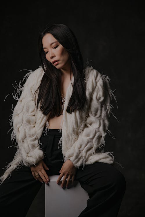 Model in White Feather Fringe Cardigan and Black Pants