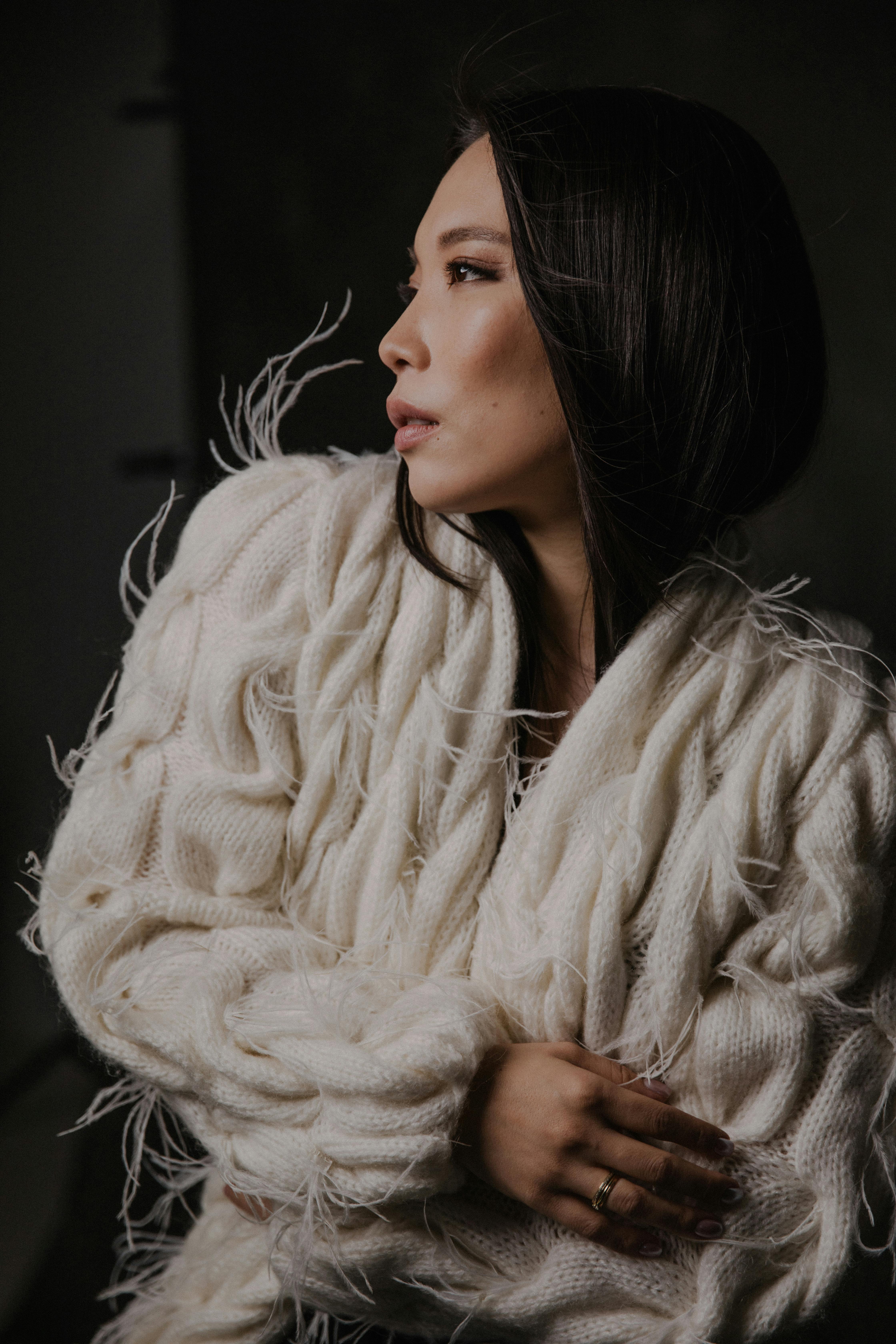 Sophisticated portrait of a woman in a white fluffy sweater, showcasing elegance and fashion.