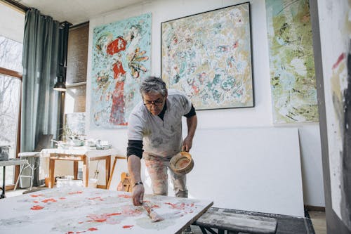 A man painting in an art studio