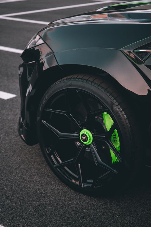 Free Close-up of a luxury car wheel with striking green accents in Tirana, Albania. Stock Photo