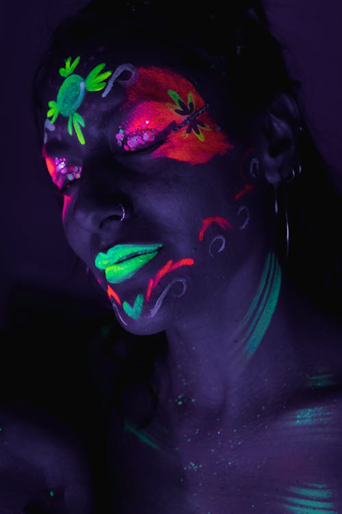 A woman with her face painted in black and white
