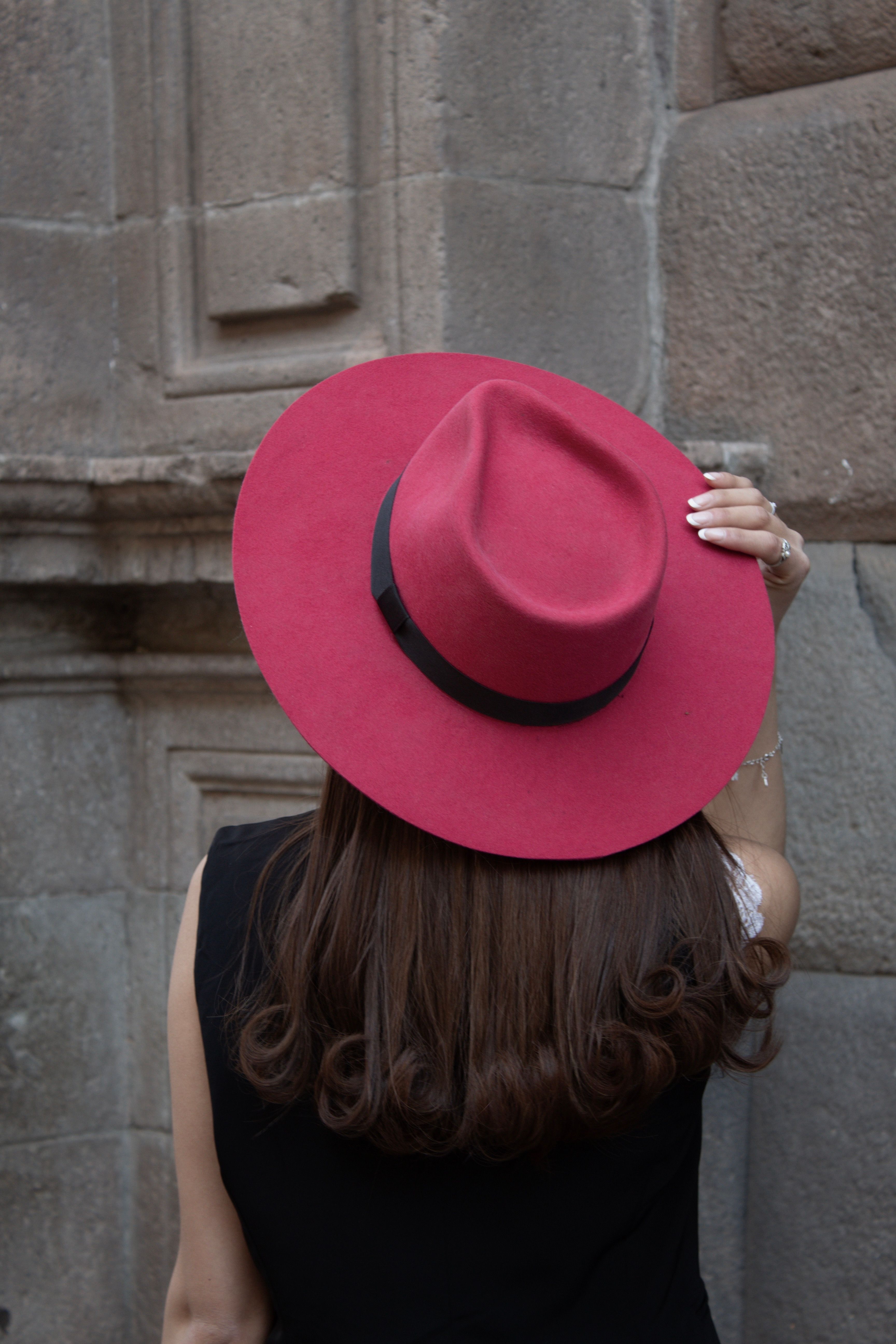 A woman wearing a red hat and black dress · Free Stock Photo