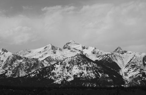Free Majestic snow-covered mountains in winter under a cloudy sky. Stock Photo