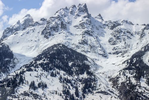 A snow covered mountain with a snow covered sky