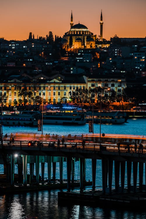 The city of istanbul at night with a bridge and a mosque