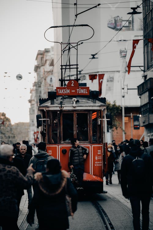 A red trolley on a city street