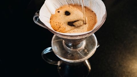 Top view of a pour-over coffee brewing process using a filter dripper set.