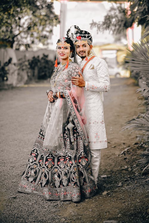 A couple in traditional indian attire posing for a photo