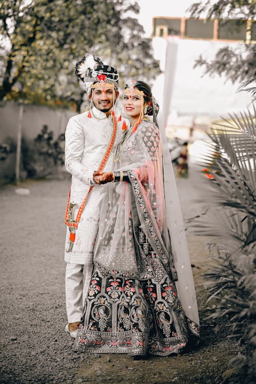 A couple in traditional attire posing for a photo