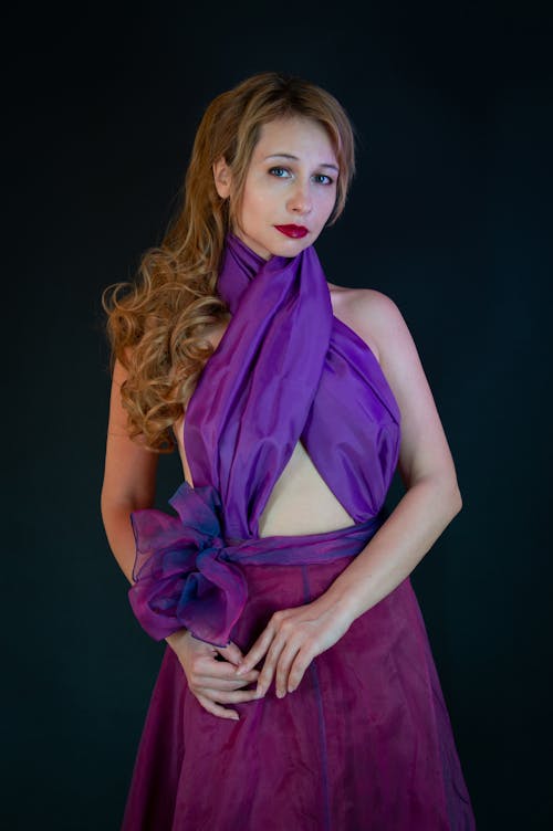 A woman in a purple dress posing for a photo