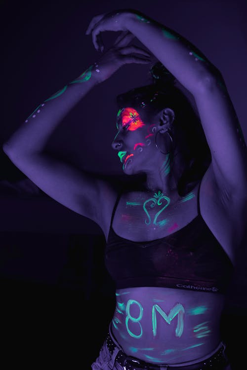 A woman in black and purple paint on her body