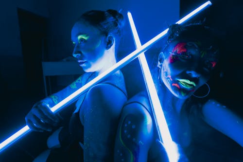 Two women with glowing lights on their faces
