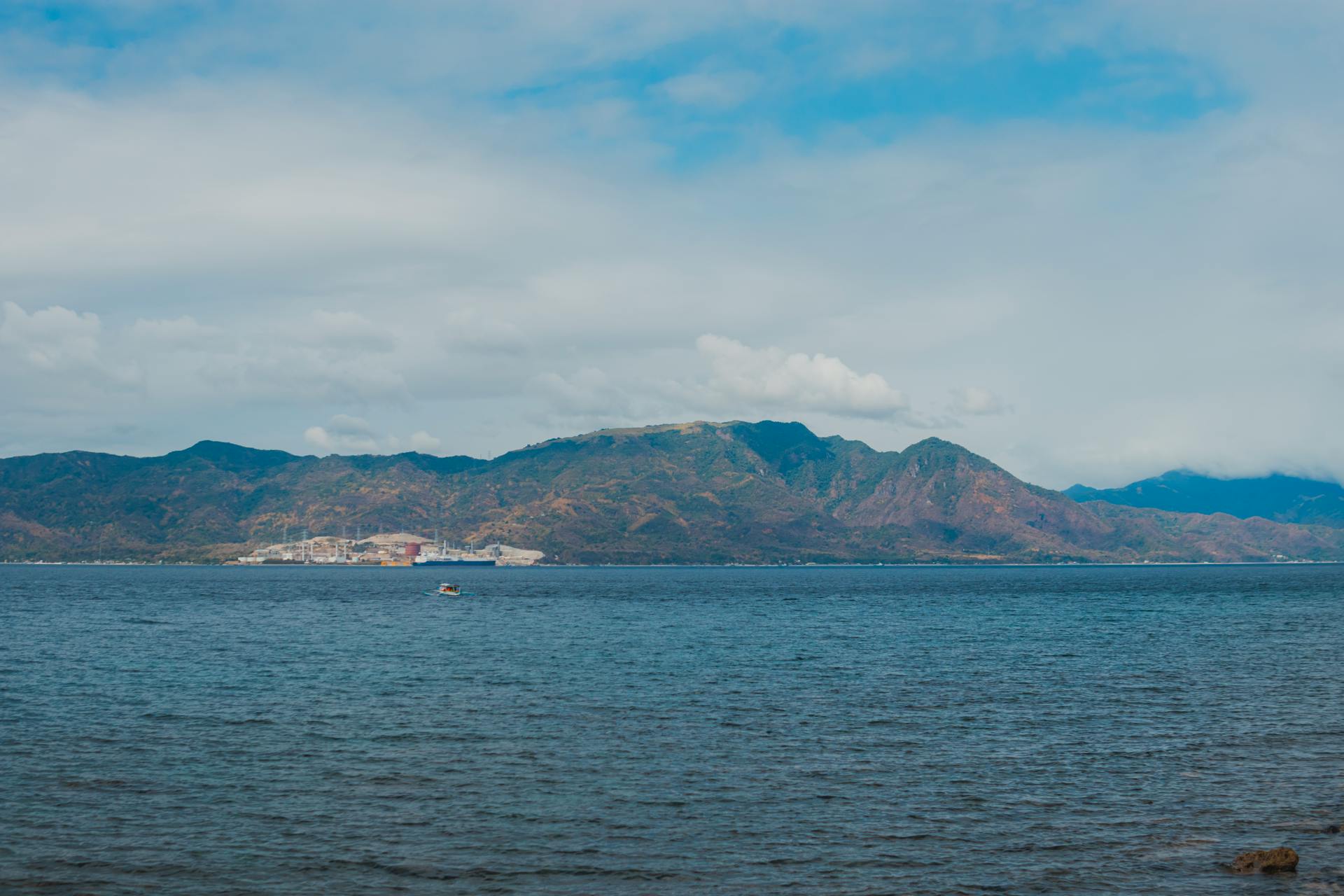 Captured panorama of Subic Bay with mountain backdrop under a blue sky.