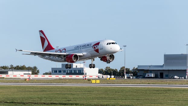 Czech Airlines Airbus A320 landing smoothly at Prague's airport on a sunny day.