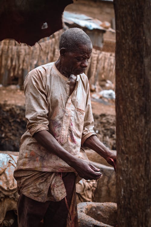 A man is working in a mud hut