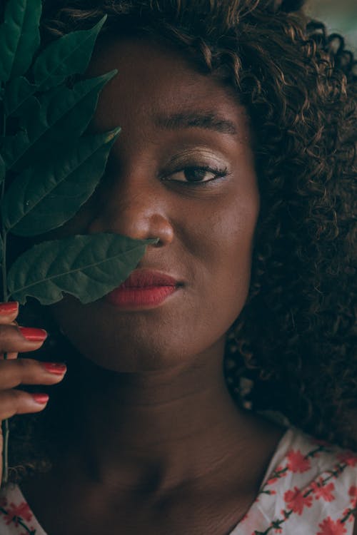 Free Close-up Photo of Woman Holding Green Leaf Over Her Eye Stock Photo