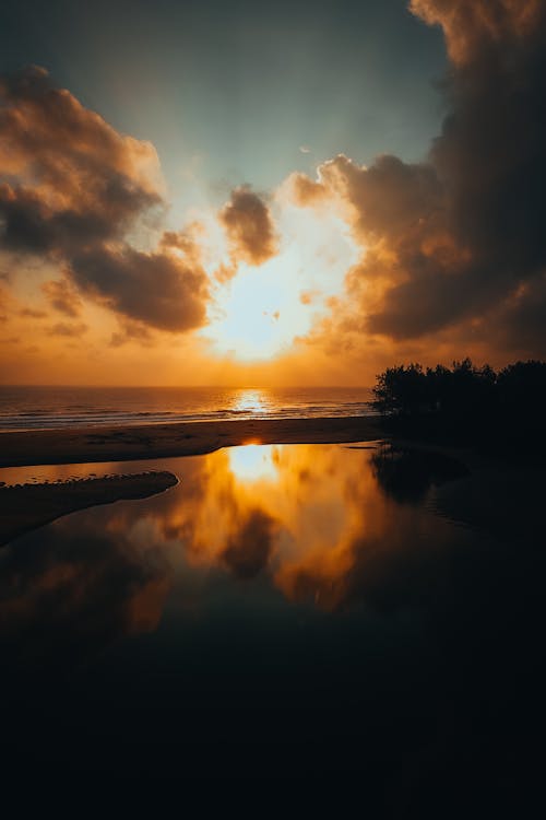 Sunset over the ocean with clouds and water