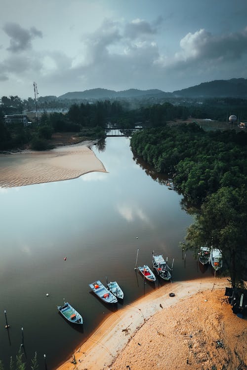 A river with boats on it and a beach