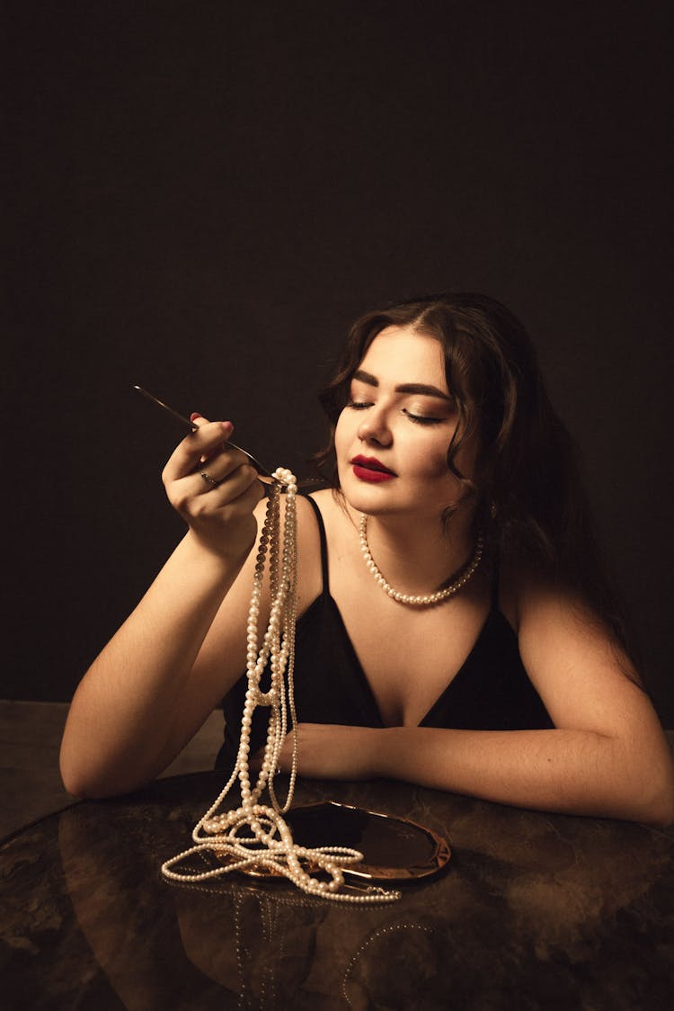 Woman Eating Pearl Necklace With Fork Like Pasta