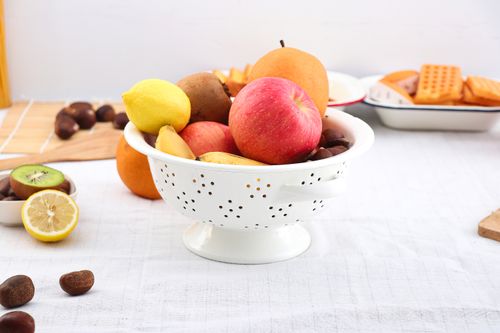 Free A vibrant assortment of fruits in a bowl on a breakfast table setting. Stock Photo