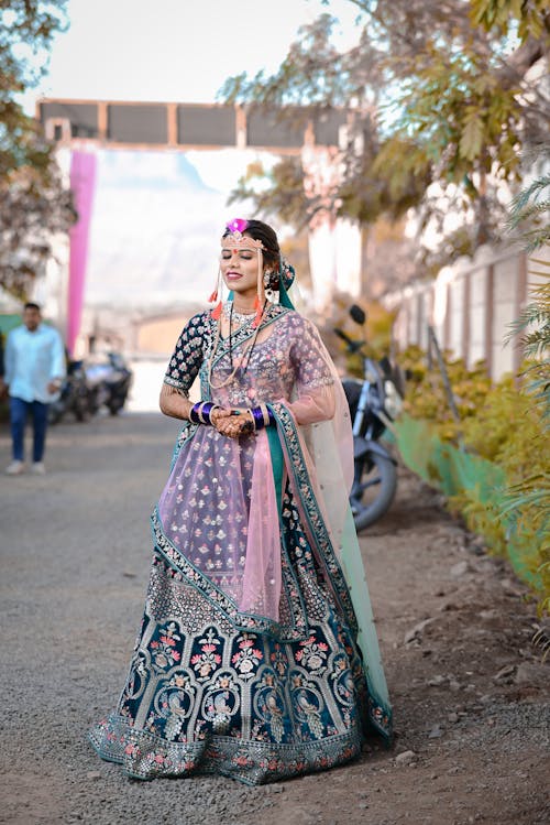 A woman in a blue and pink lehenga