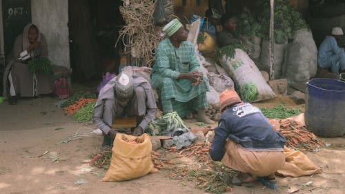 Men Sitting in Village and Working