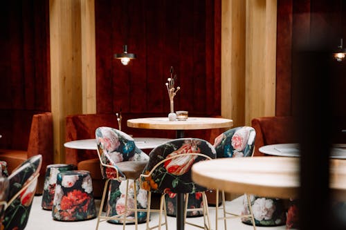 A bar with red and pink chairs and tables
