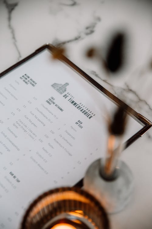 A menu with candles on a marble table