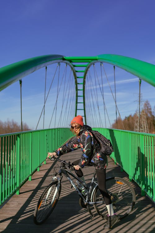 A person riding a bike on a bridge
