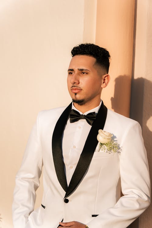 Groom in a White Tuxedo with Black Lapels and a Bow-tie