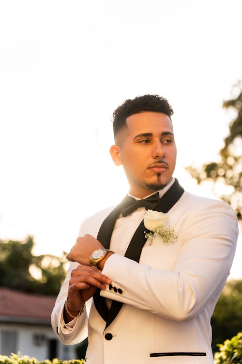 Back Lit Photograph of a Bridegroom Holding a Cuff