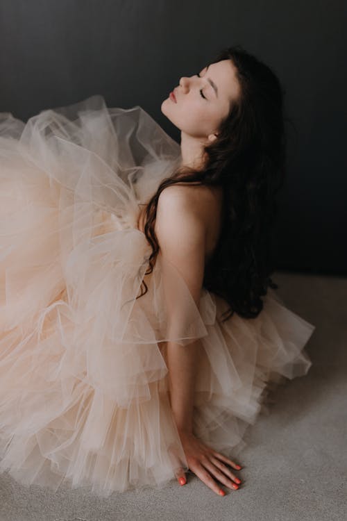 Woman in Dress Sitting with Eyes Closed