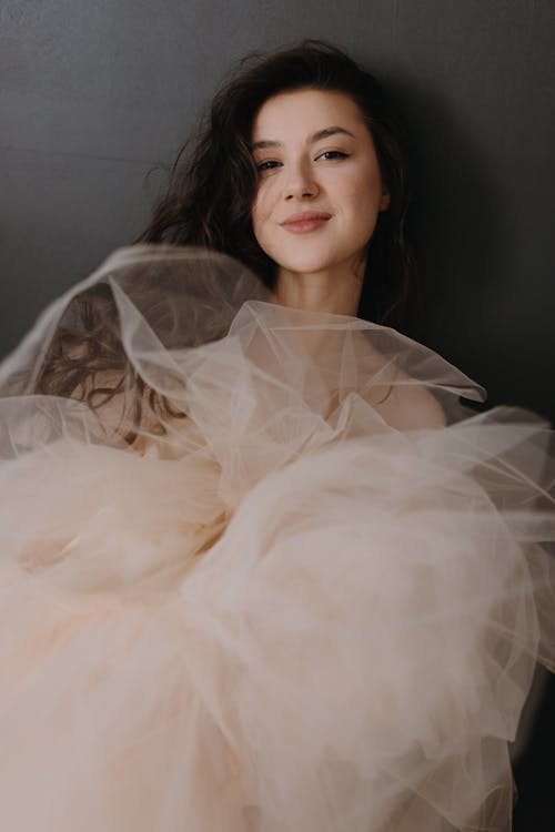 A woman in a tulle dress posing for a portrait