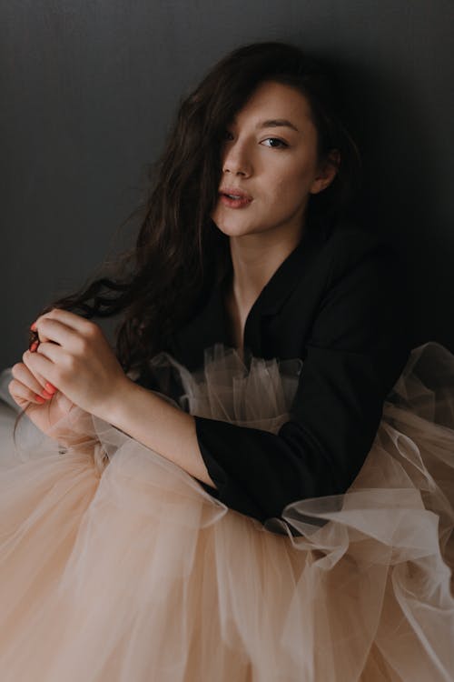 A woman in a black top and tulle skirt