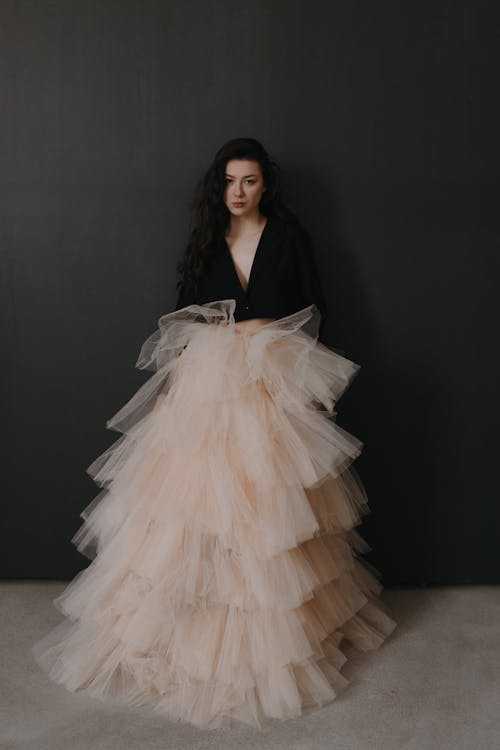 A woman in a blush tulle skirt