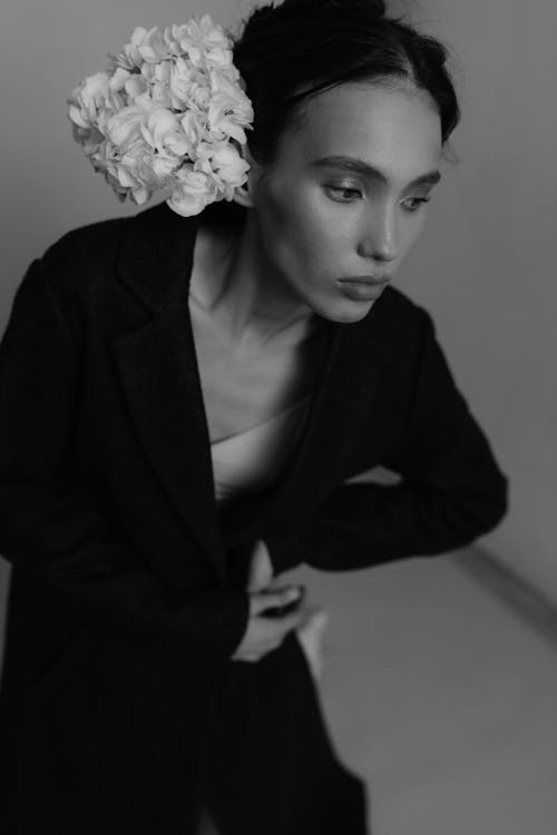 A woman in a coat and flowers on her head